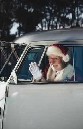 Santa Claus waving from old van