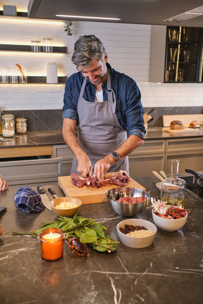 Man in apron cooking in kitchen