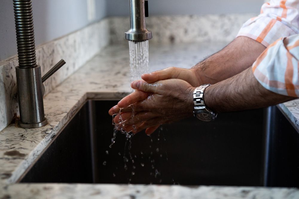 Close up cropped shot on man washing his hands with soap and water