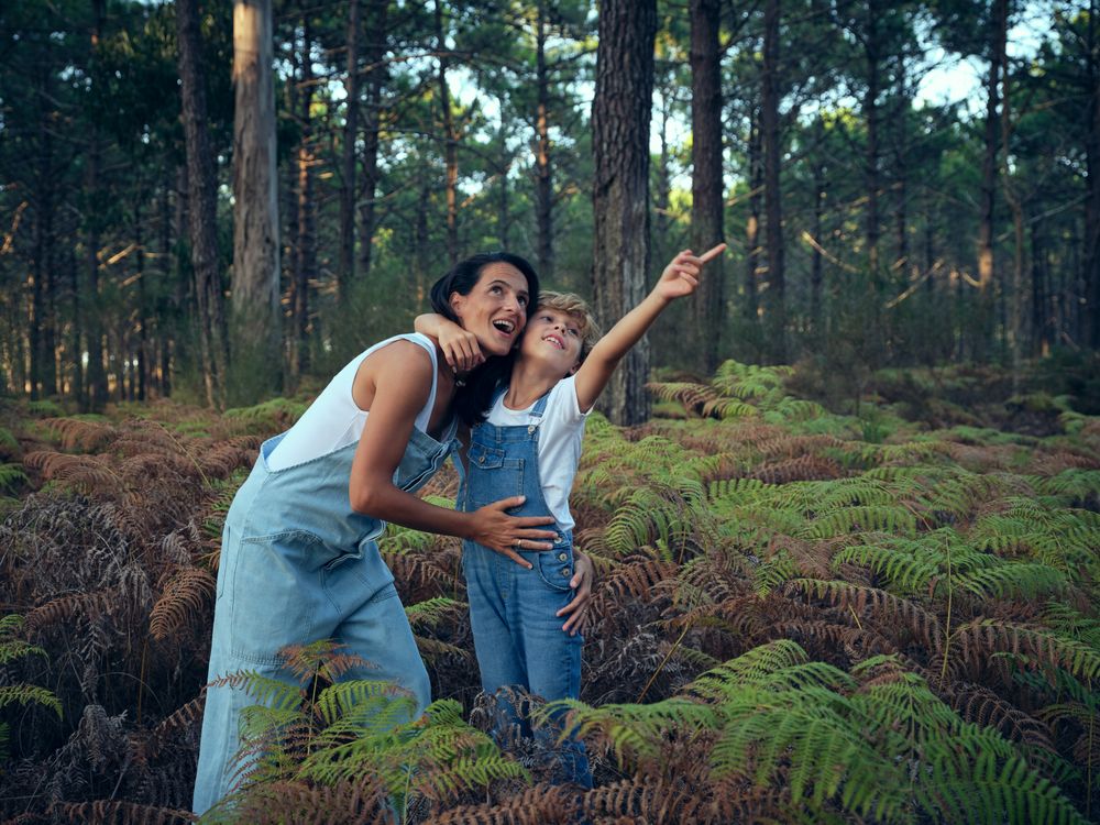 Mother and son walking in woods