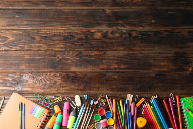Flat lay composition with school supplies on wooden background, space for text