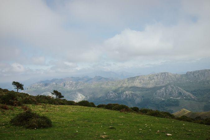Astonishing view of green forested valley under cloudy sky in summer