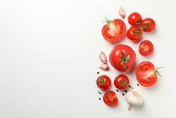 Composition with tomatoes and ingredients on light background, top view