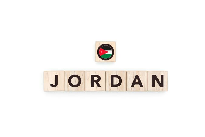 Wooden blocks bearing the name and flag of Jordan.
