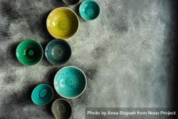 Empty colorful ceramic bowls on stone background 5RVEzO