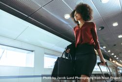Black woman with curly hairstyle traveling by plane 5RjyN5