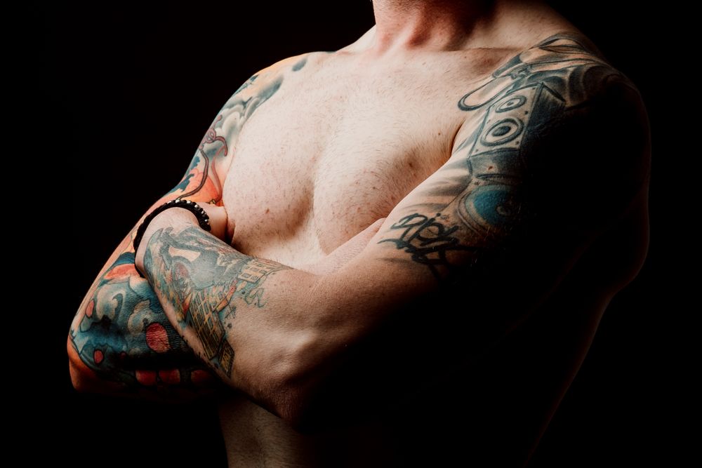 Young shirtless guy with tattoos
