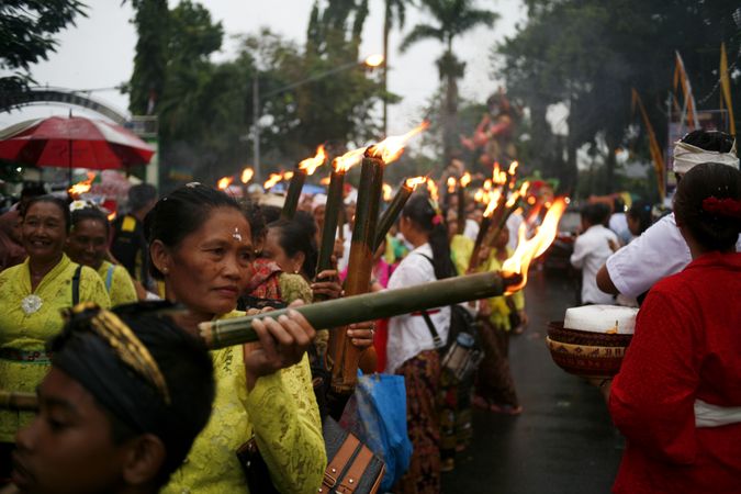 Group of Indonesian Hindu women with torches marches during Nyepi day
