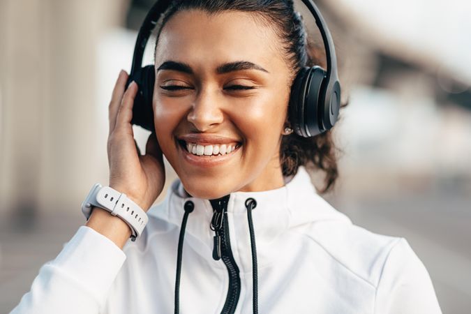 Smiling woman listening to music in headphones