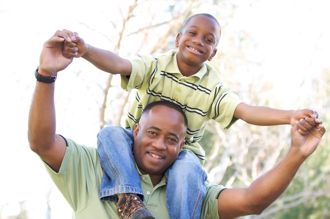 Happy Black Man and Child Having Fun