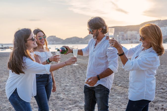 Happy family drinking wine on beach