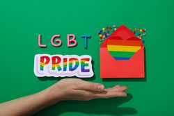 LGBT parade concept, envelope on green background.