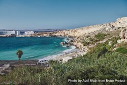 Looking down at small idyllic Maltese beach surrounded by cliffs 4MjQyb