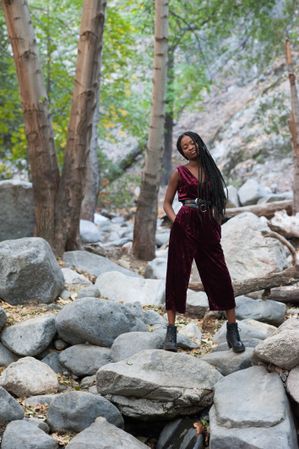 Content and fashionable woman standing outdoors