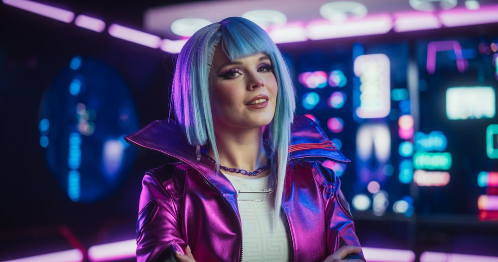 Portrait of a Stylish Cyberpunk Cosplay Model with Blue Hair Posing in Front of Camera, Smiling.