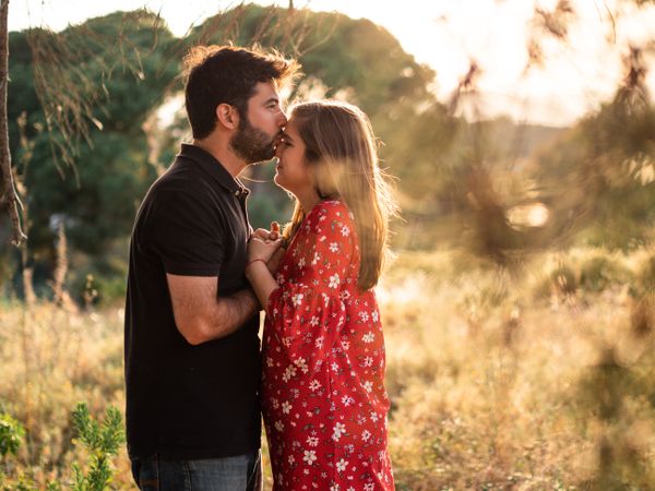Young happy couple embracing in beautiful garden