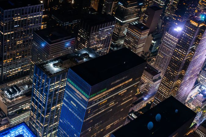 New York City Aerial Night Cityscape with Stunning Manhattan Landmarks, Skyscrapers and Residential Buildings. Helicopter Down View of the Urban Architecture