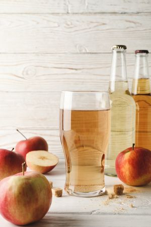 Composition with cider, sugar and apples on wooden background