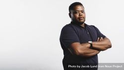 Body positive Black man standing against neutral background looking at camera 0vzm70