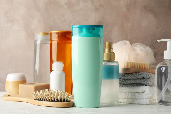 Composition with hair care products on wooden table. Blank space for label