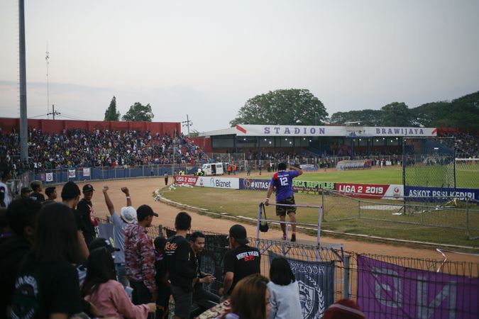 Kedira, East Java Indonesia - October 4, 2019: Fans in soccer stadium looking onto the field