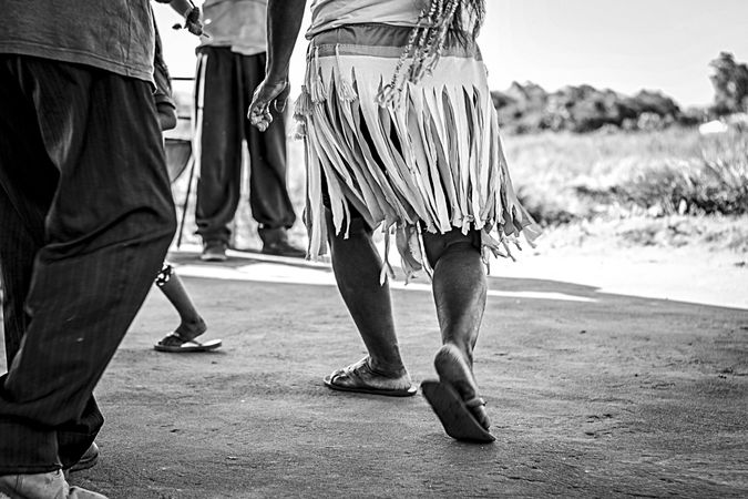 Cropped image of people's feet walking on street