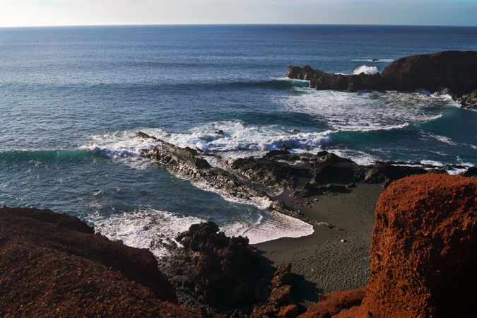 Beautiful and picturesque view of surface of sea water among high rocky cliffs on sunny day
