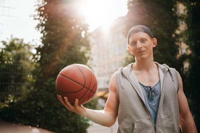 Male streetball player with a ball in hand