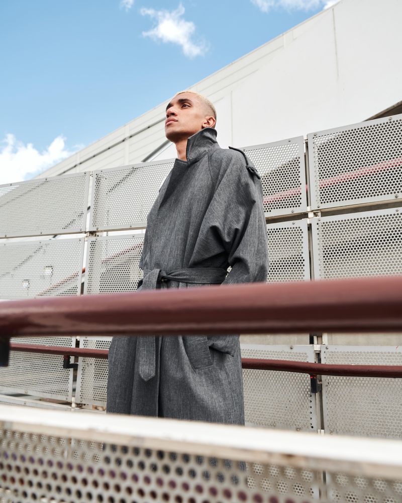 Stylish young man looking off in the distance on walkway