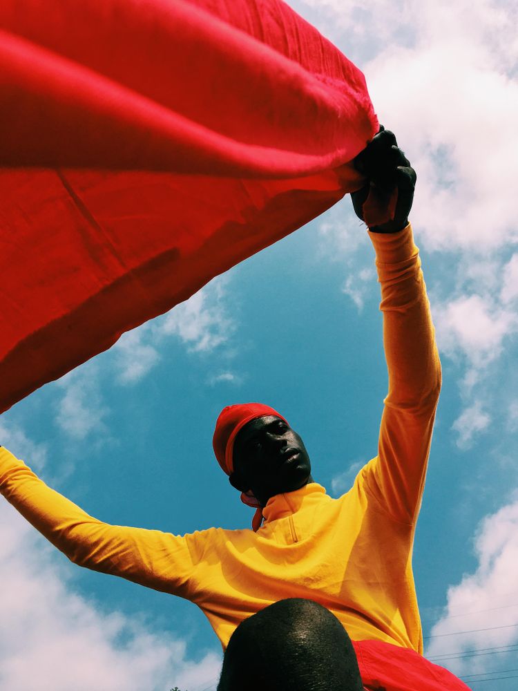 Man holding red textile outdoor