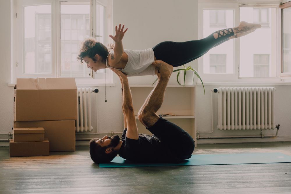 couple practicing yoga together at home