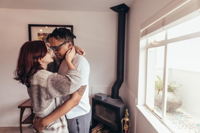Romantic man and woman embracing each other at home
