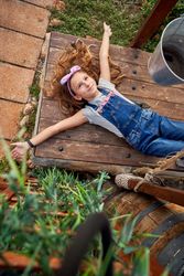 Girl resting on wooden surface in countryside