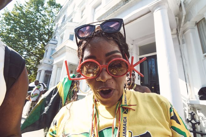 London, England, United Kingdom - August 25th, 2019: Woman in Jamaican attire with party glasses