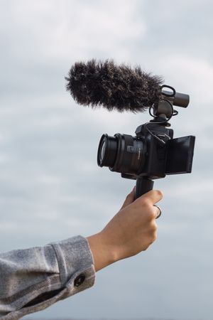 Anonymous female blogger shooting video on camera