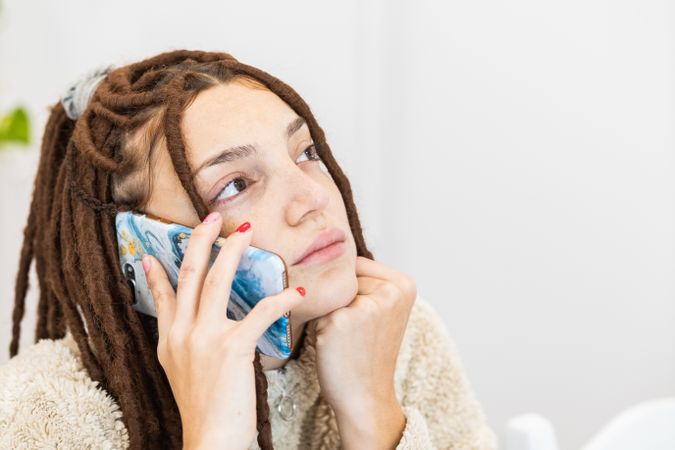 Close-up of a woman with braids using the mobile