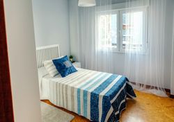 Bedroom decorated with quilt and curtains