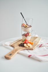 Glasses with delicious dessert served on table
