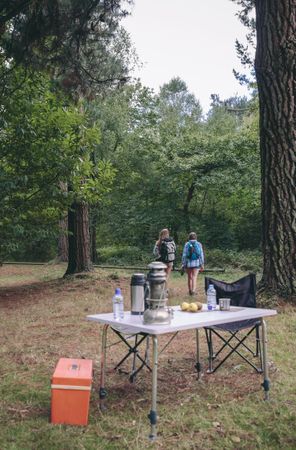 Women hiking with camping table in foreground