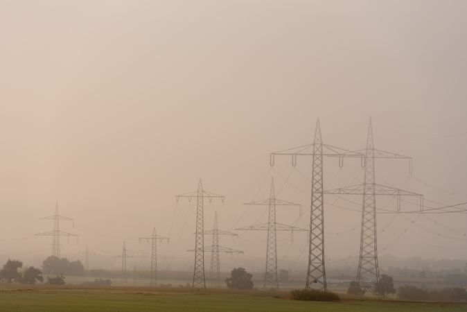Electricity pylons in a german rural scenery on a foggy morning