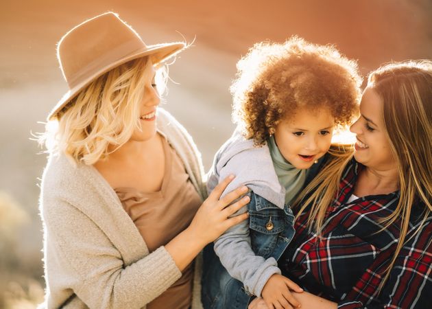 Smiling blond women walking with curly child