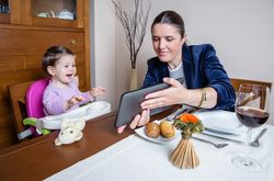Businesswoman mother and baby girl looking tablet