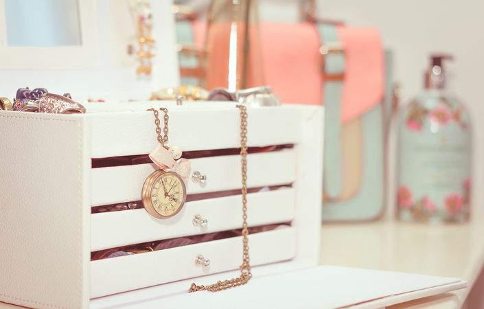 Jewelry with vintage clock and female complements in soft pastel colors
