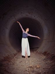Graceful woman dancing ballet in shabby tunnel