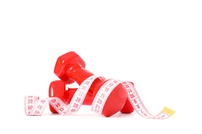 Dumbbells and measuring tape isolated on plain background