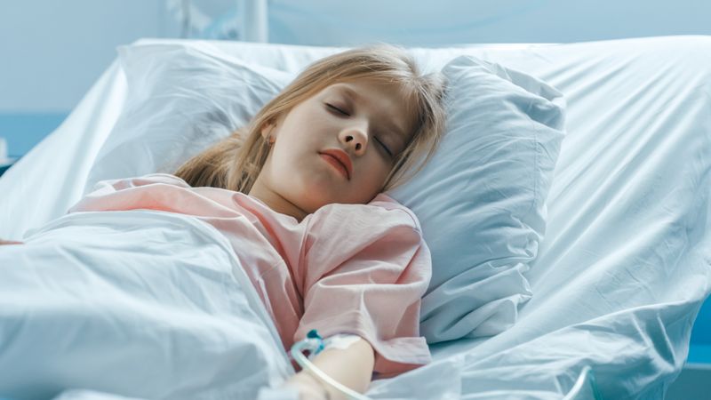 Cute Little Sick Girl Sleeps on a Bed in the Children's Hospital