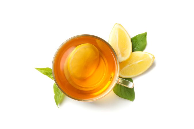Tea and lemons isolated on bright background, top view