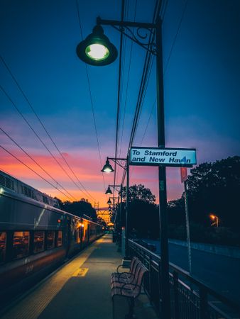 Bench near train during early evening in Village of Pelham, New York, United States