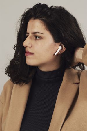 Woman with earbuds in studio