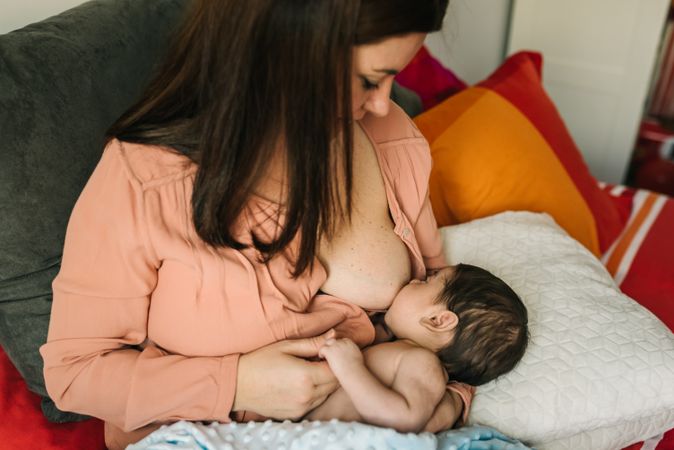 Mom breastfeeding at home